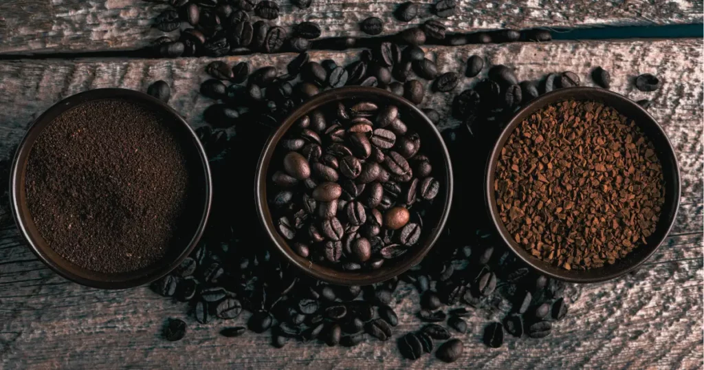 three bowls of coffee beans on a wooden table | hustle coffee