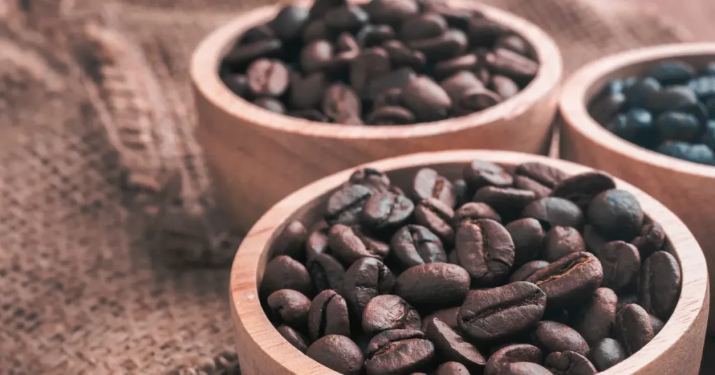 three wooden bowls filled with coffee beans | hustle coffee
