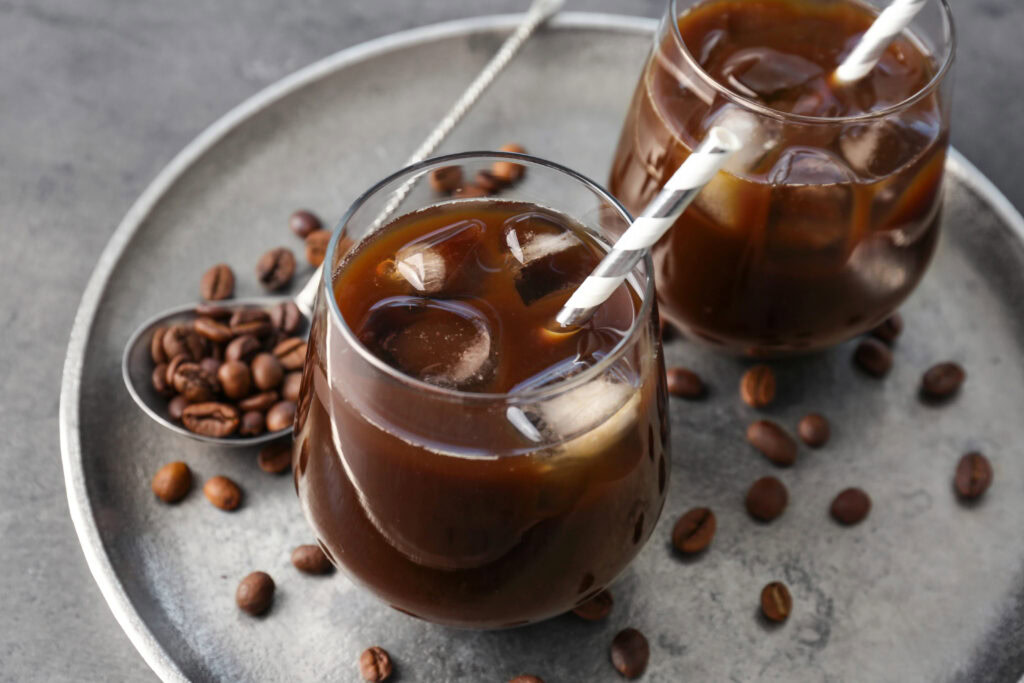 ice americano coffee and coffee beans in the table | Hustle Coffee