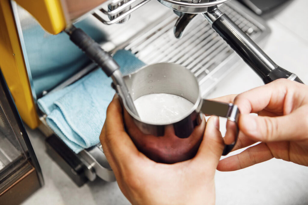 barista hands working on making creamer | Hustle Coffee
