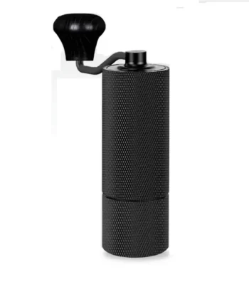 Black manual coffee grinder with a textured body and a crank handle on top against a white background. | Hustle Coffee