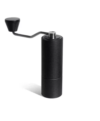 Black manual coffee grinder with a crank handle on a white background. | Hustle Coffee