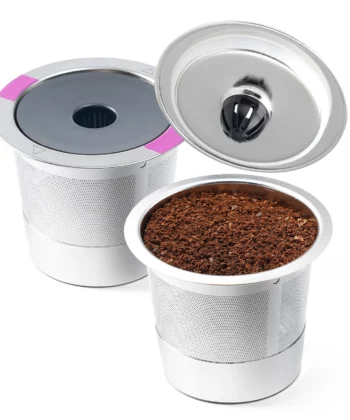 Two reusable coffee pods, one filled with coffee grounds and the other with a closed lid, on a white background. | Hustle Coffee
